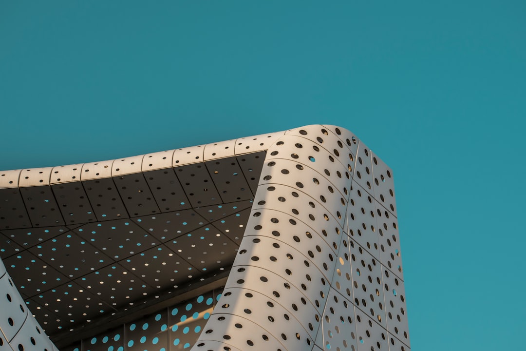 a bird is perched on the side of a building