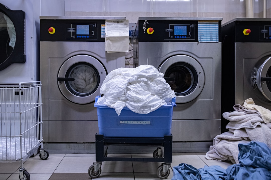 a laundry room with a washing machine and a laundry basket